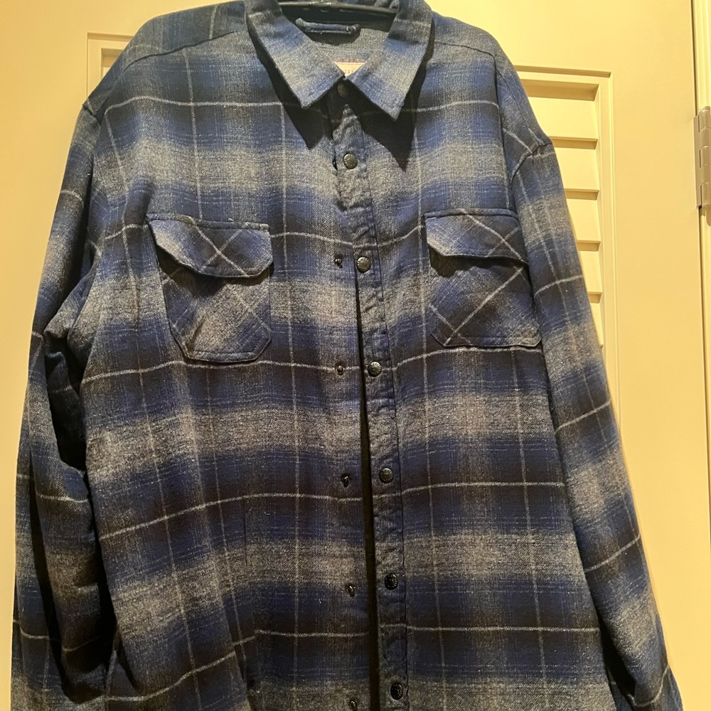Shirt jacket has snaps down the front. Two front pockets and two side pockets.